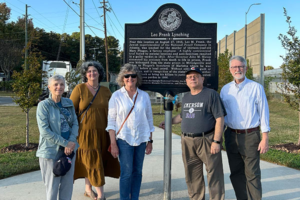 Five members of the coalition standing in front of the Leo Frank memorial marker